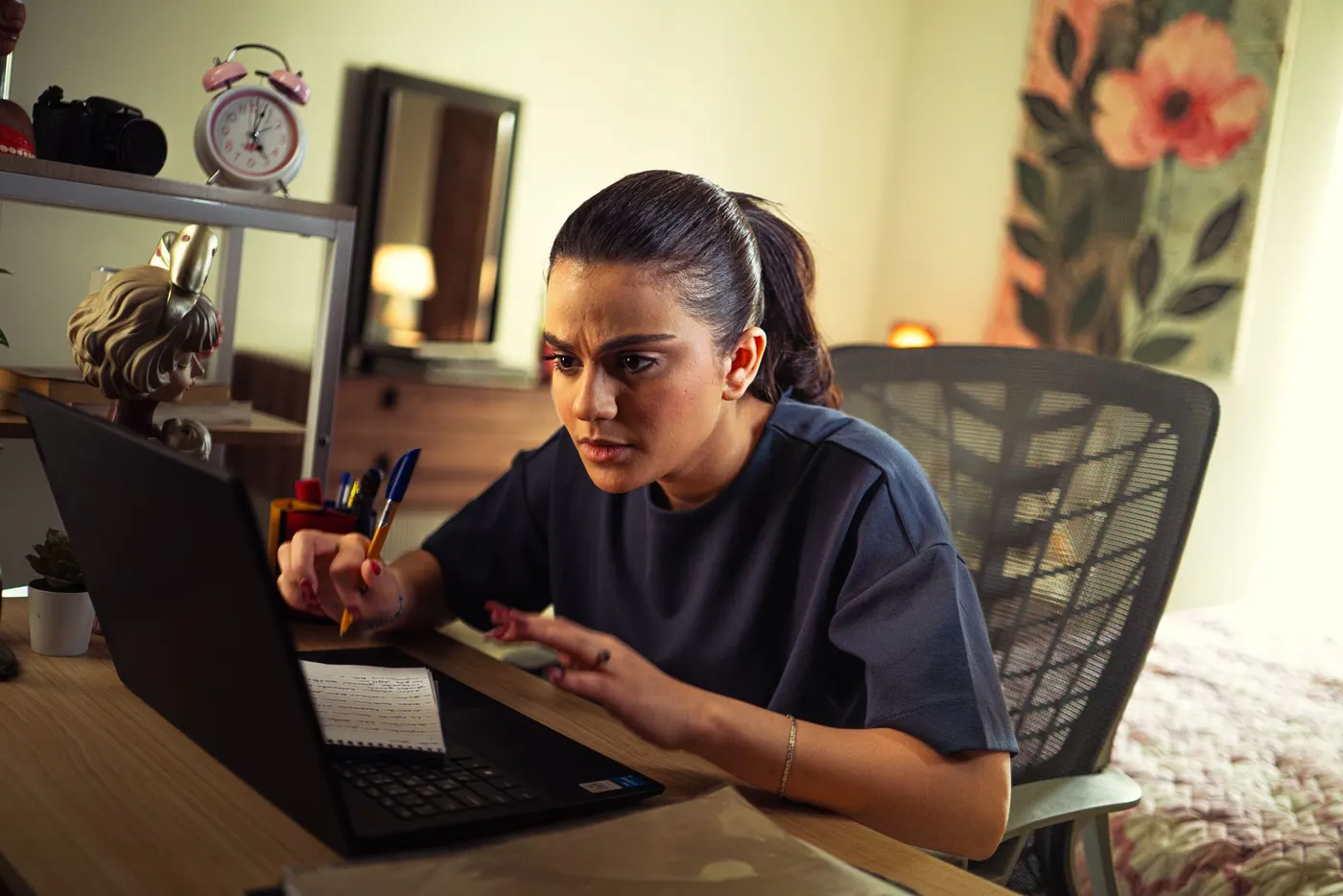 A candidate studying for a licensing exam at a desk with a laptop